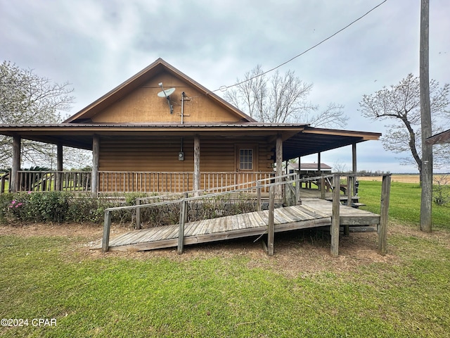 exterior space featuring a lawn and a wooden deck