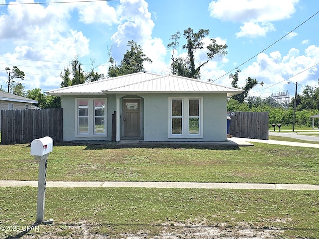 bungalow-style home with a front yard