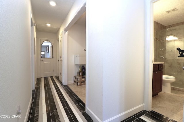 hall featuring tile patterned flooring