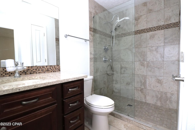 bathroom featuring backsplash, vanity, a textured ceiling, toilet, and an enclosed shower