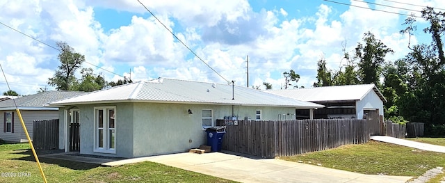 back of house with a lawn