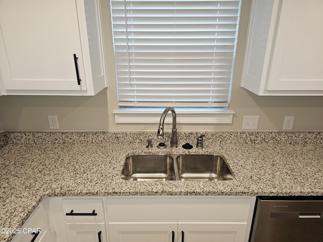 details with dishwasher, light stone countertops, sink, and white cabinets