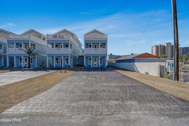 view of front of home with a balcony and french doors