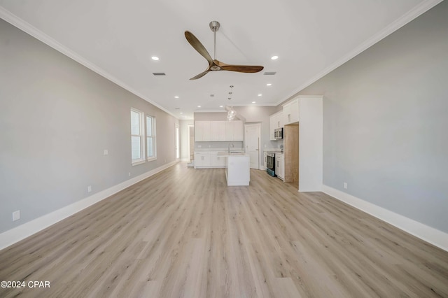 unfurnished living room with sink, ceiling fan, light wood-type flooring, and crown molding