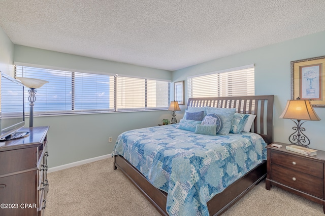 carpeted bedroom with a textured ceiling