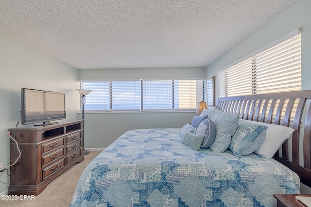 carpeted bedroom with a textured ceiling