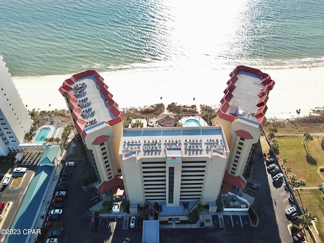 aerial view with a water view and a beach view