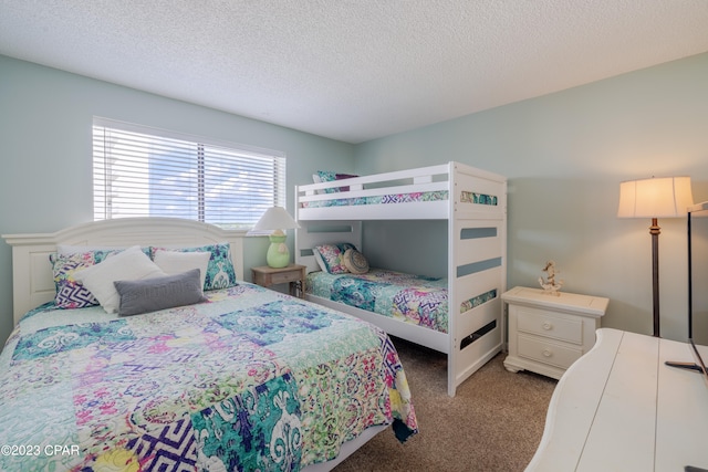 bedroom featuring a textured ceiling and light colored carpet