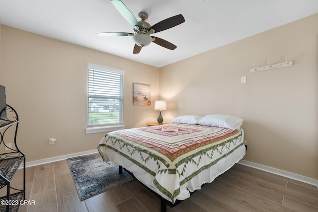 bedroom with dark wood-type flooring and ceiling fan