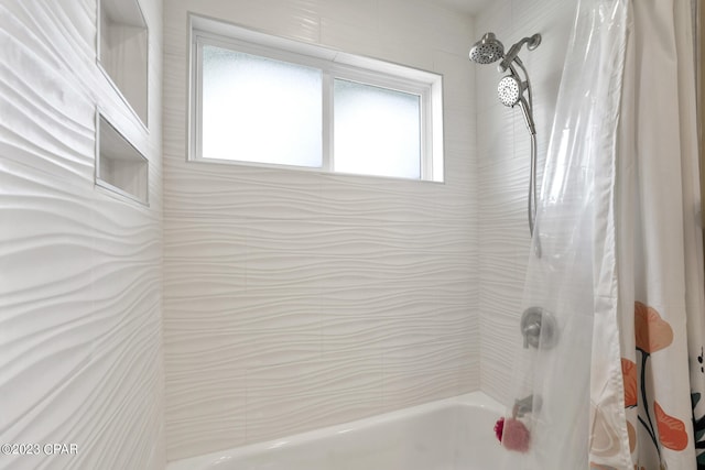 bathroom with shower / bath combo with shower curtain