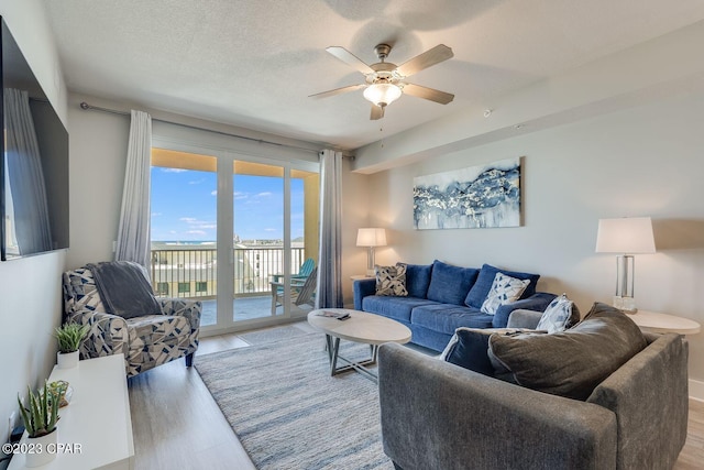 living room featuring ceiling fan and light hardwood / wood-style floors