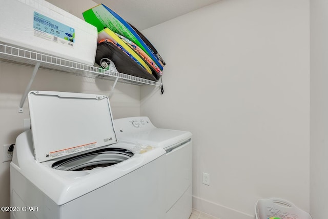 clothes washing area with washer and clothes dryer