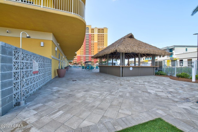 balcony with a water view and a view of the beach