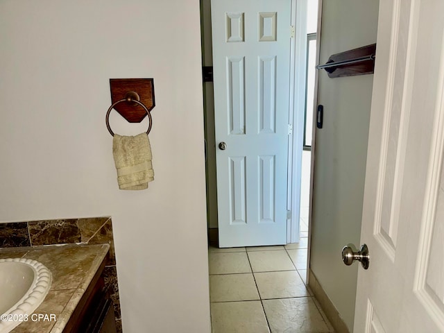 bathroom with tile floors and vanity