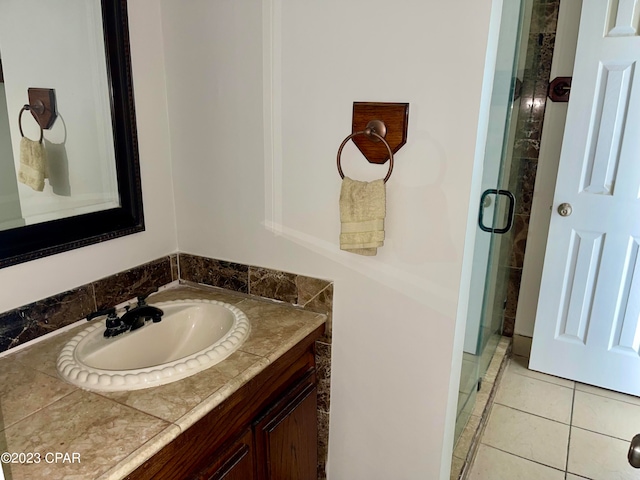 bathroom featuring walk in shower, tile flooring, and oversized vanity