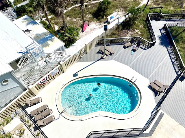 view of swimming pool with a hot tub and a patio