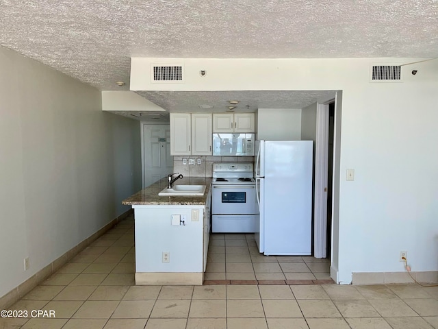 kitchen with light tile flooring, white appliances, sink, white cabinets, and tasteful backsplash