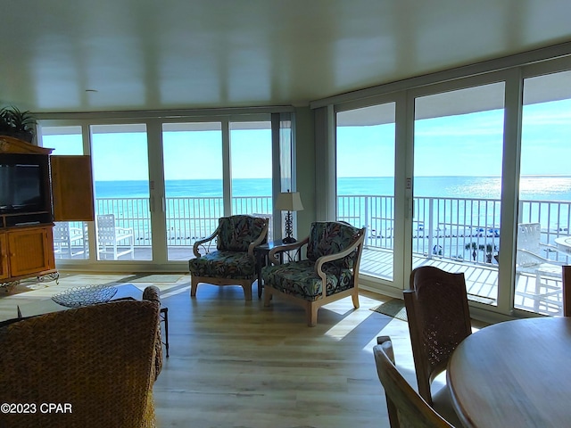 interior space with a water view and wood finished floors