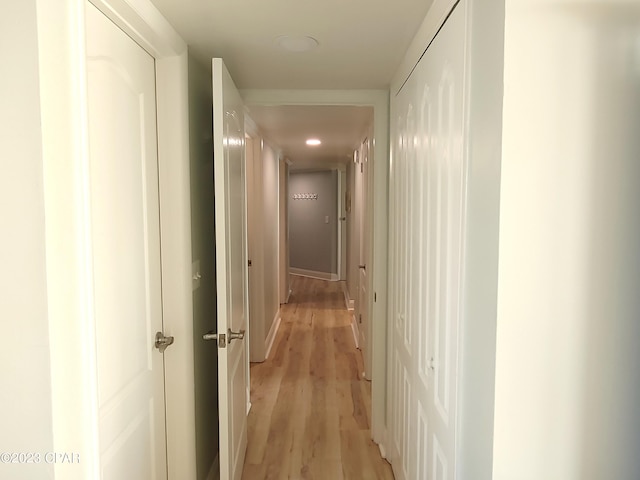 corridor featuring light wood finished floors