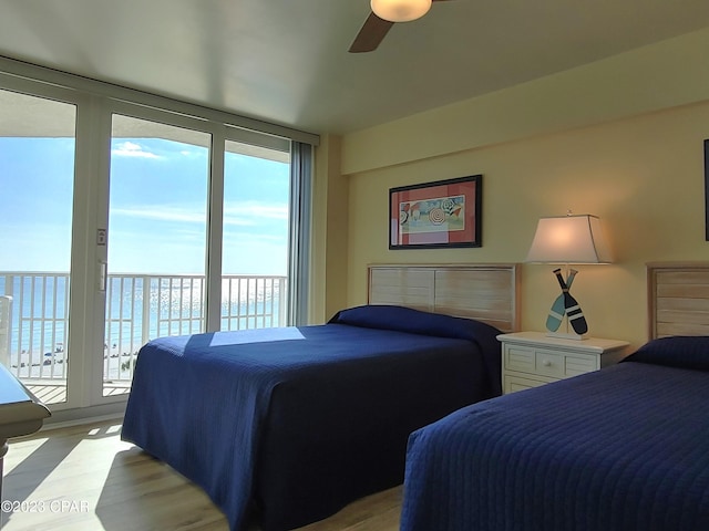 bedroom with light wood-type flooring, access to exterior, and a ceiling fan