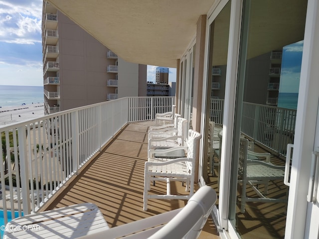 balcony with a beach view and a water view