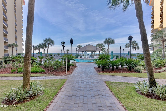 surrounding community with a pool and a gazebo