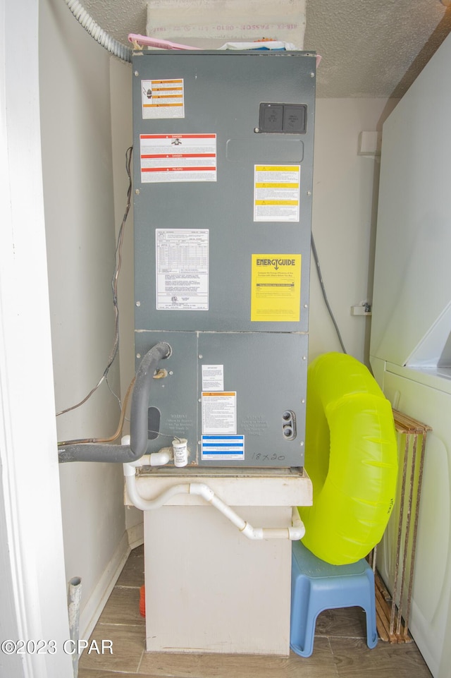 utility room featuring heating unit