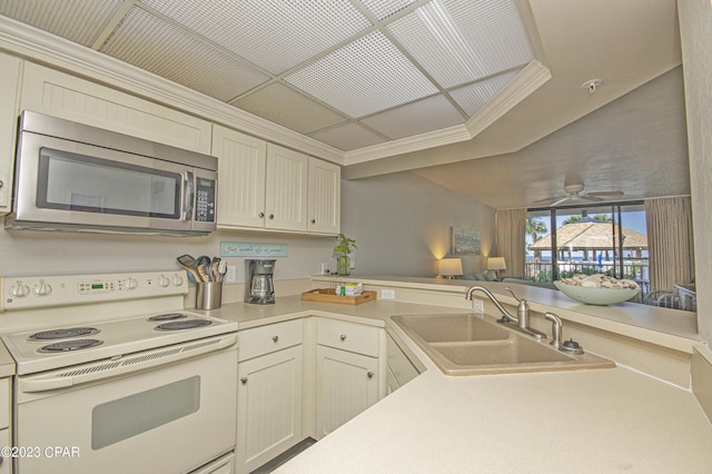 kitchen with sink, crown molding, white electric stove, ceiling fan, and cream cabinets