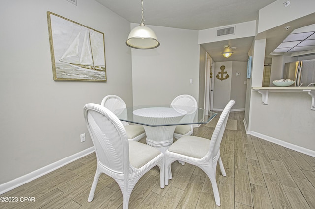 dining space with light wood-type flooring