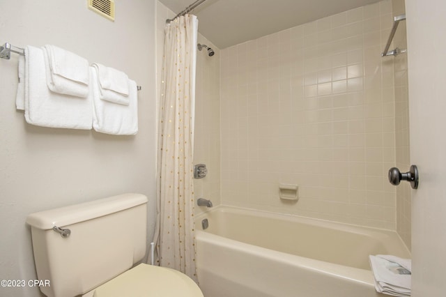 bathroom with shower / tub combo with curtain and toilet