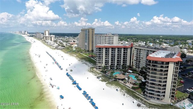 birds eye view of property with a view of the beach and a water view