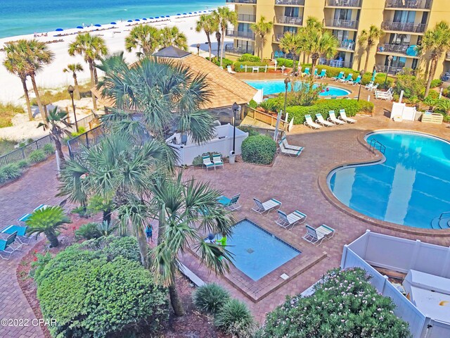 view of pool with a view of the beach and a water view