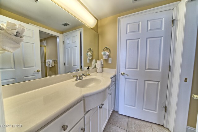 bathroom with vanity and tile patterned flooring