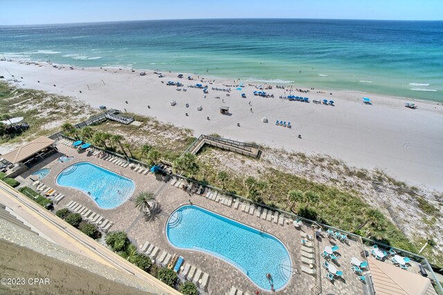 birds eye view of property featuring a water view and a beach view