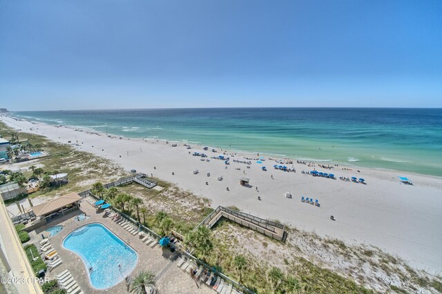 drone / aerial view featuring a water view and a beach view