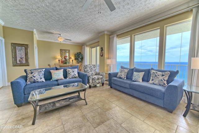 living room featuring a water view, ceiling fan, and crown molding