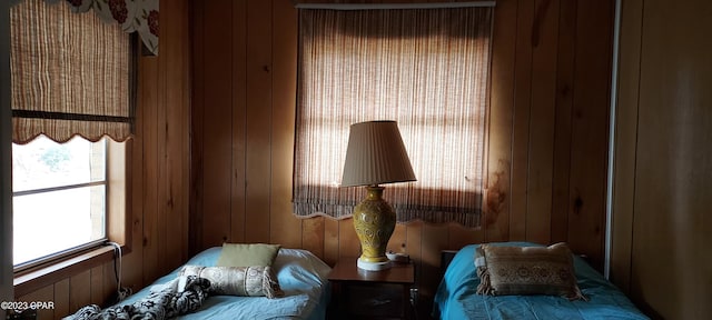 bedroom featuring wood walls