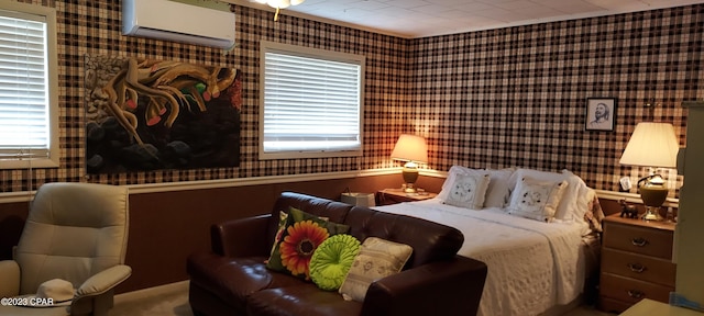 bedroom featuring multiple windows and a wall mounted air conditioner