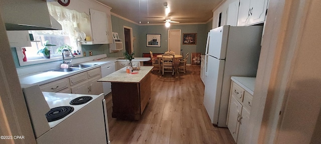 kitchen with a kitchen island, white fridge, ceiling fan, white cabinetry, and light wood-type flooring