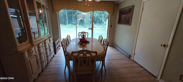 dining room with ceiling fan, light hardwood / wood-style flooring, and baseboard heating