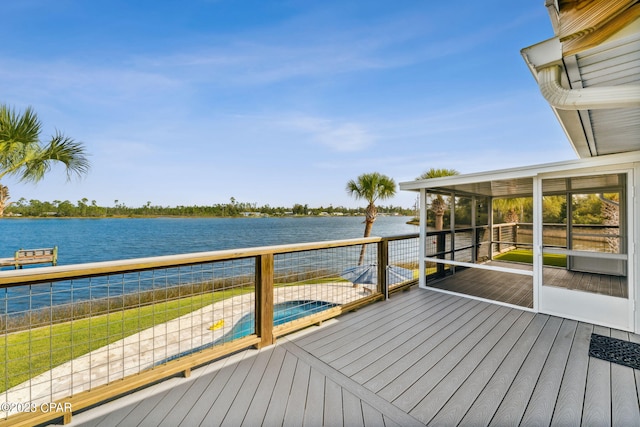 deck with a swimming pool and a water view