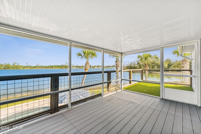 unfurnished sunroom with a water view