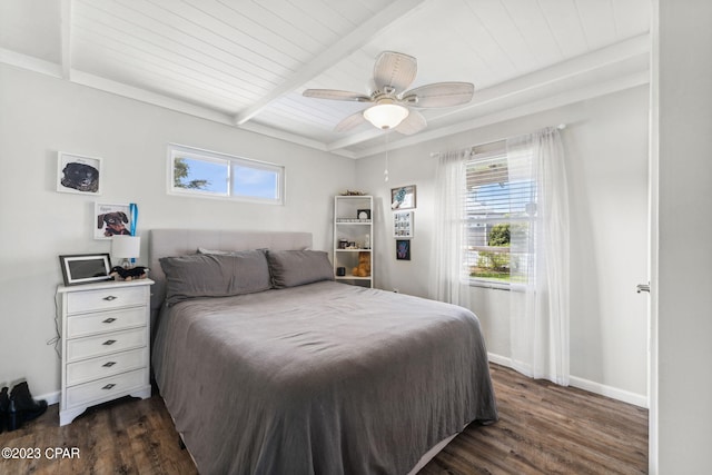 bedroom featuring multiple windows, dark hardwood / wood-style flooring, and beamed ceiling