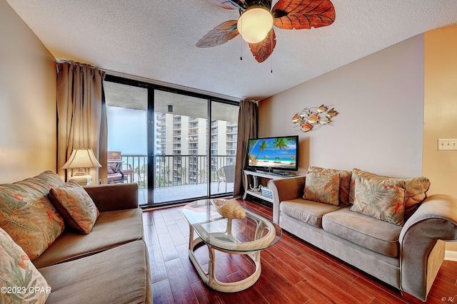 living room with hardwood / wood-style floors, floor to ceiling windows, a textured ceiling, and ceiling fan