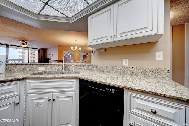 kitchen featuring sink, black dishwasher, kitchen peninsula, ceiling fan with notable chandelier, and white cabinets