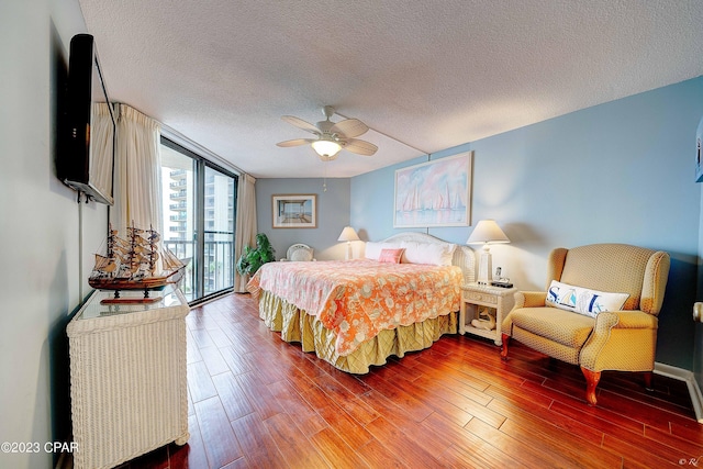 bedroom with floor to ceiling windows, wood-type flooring, a textured ceiling, access to outside, and ceiling fan