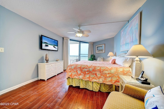 bedroom featuring hardwood / wood-style flooring, ceiling fan, access to outside, and a textured ceiling