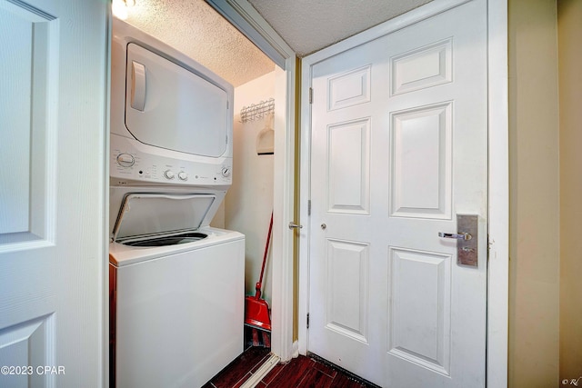 washroom featuring stacked washer / dryer and dark hardwood / wood-style flooring