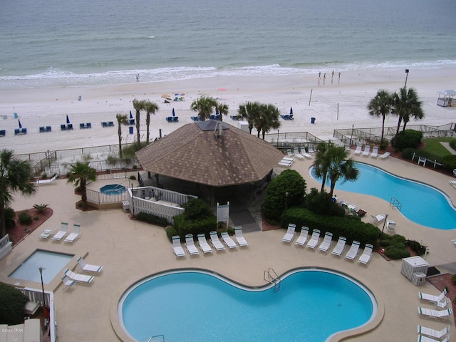 view of pool featuring a view of the beach and a water view