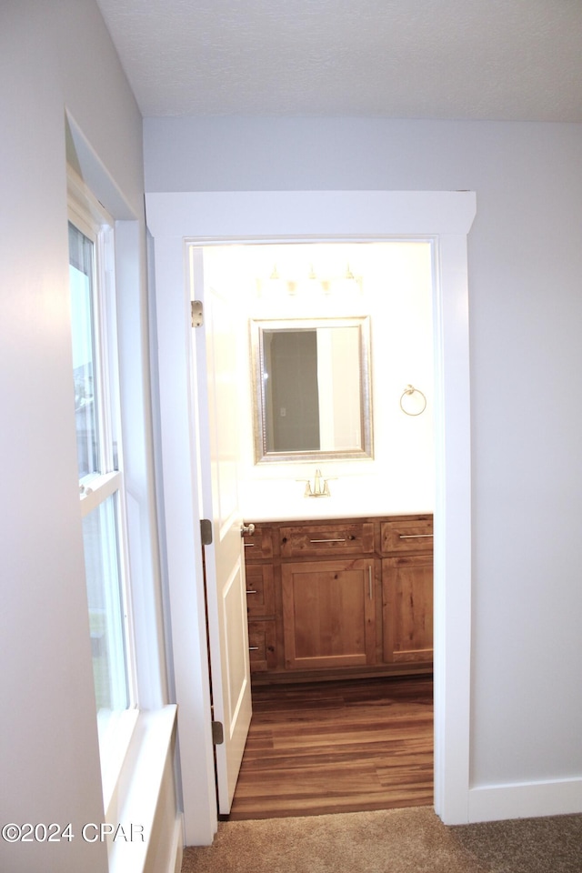 hallway featuring dark hardwood / wood-style flooring and sink